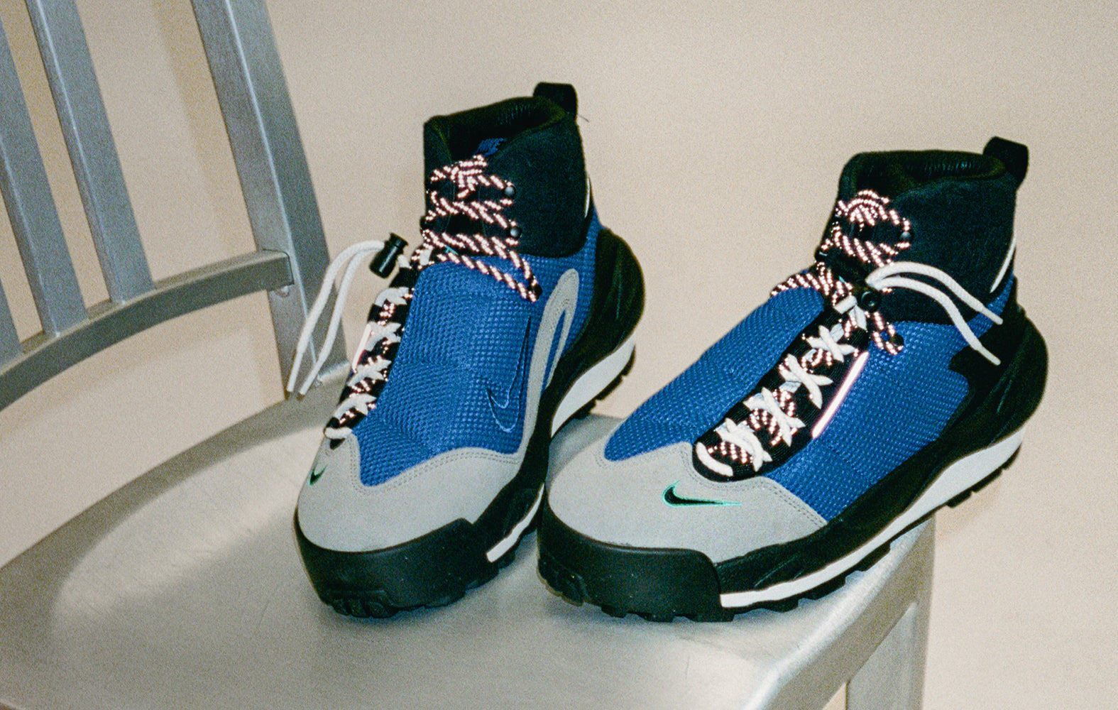 A pair of blue shoes leaning against a chair